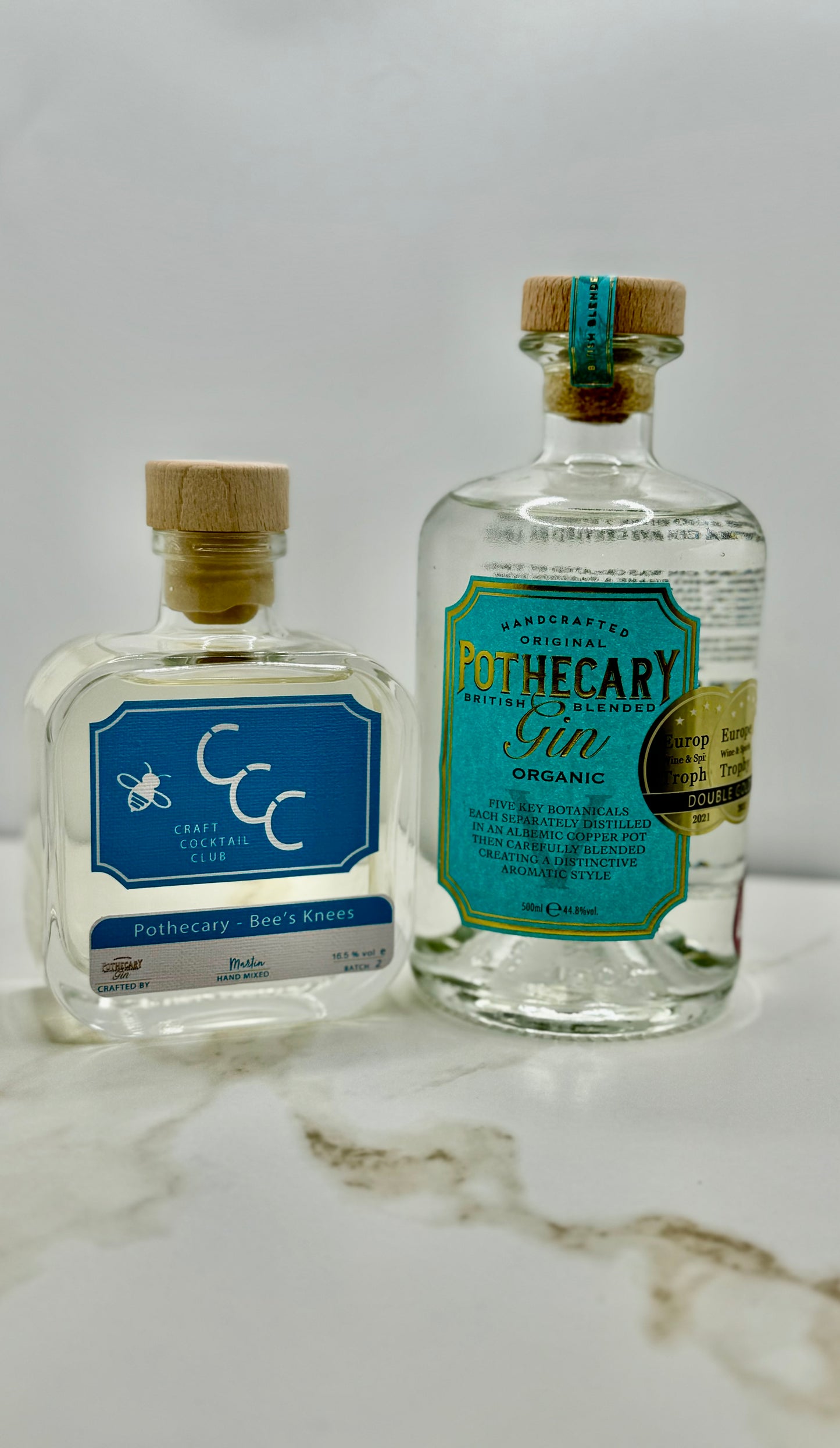 picture of two bottles of pothcary gin in a photo booth setting