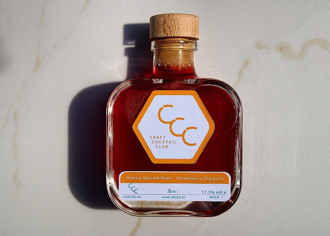 Picture of a bottle of ready to drink cocktail on a marble tile, label reads Craft Cocktail Club Strawberry Daiquiri