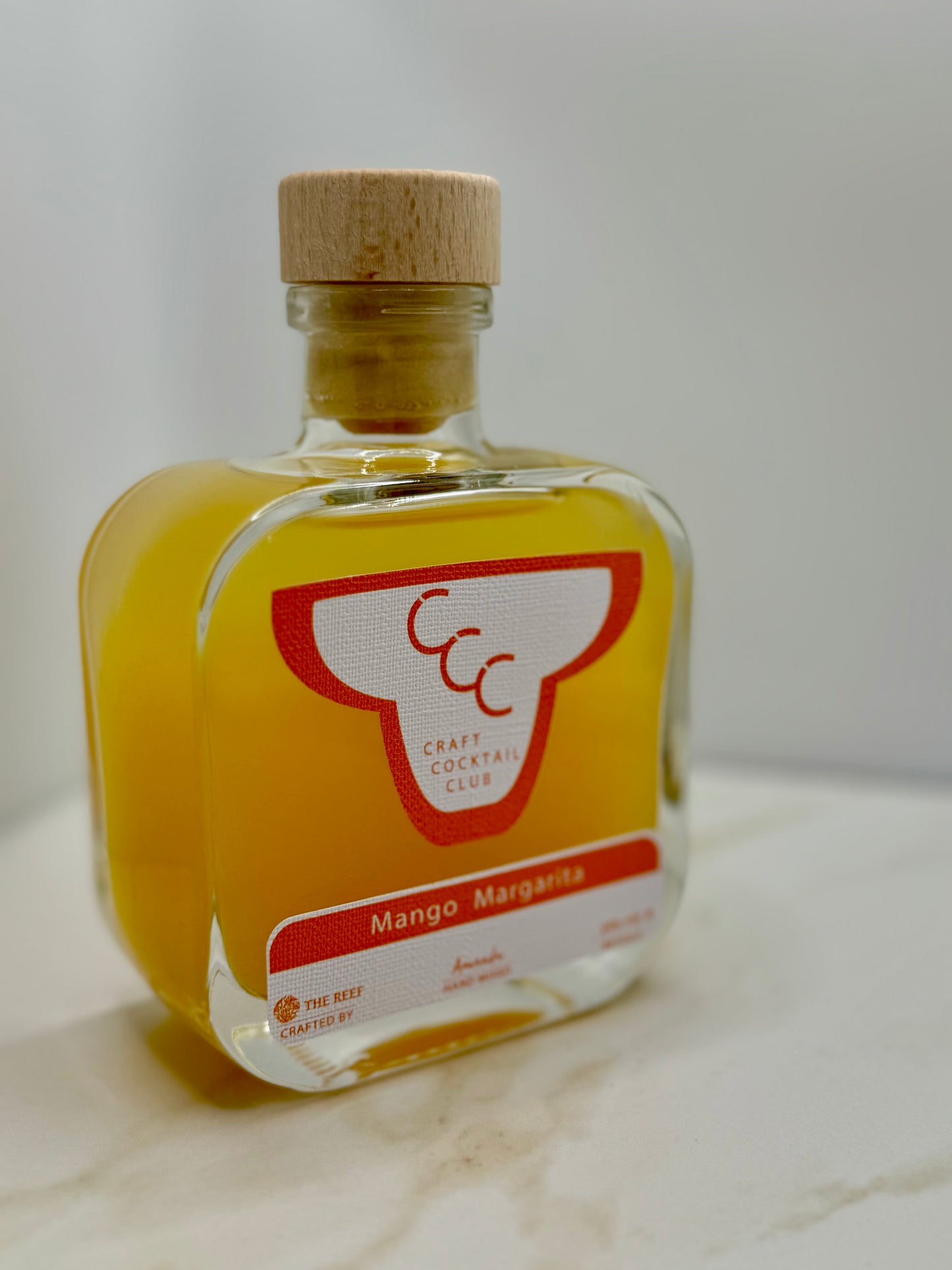picture of a single bottle with orange content, its a craft cocktail club margarita bottle