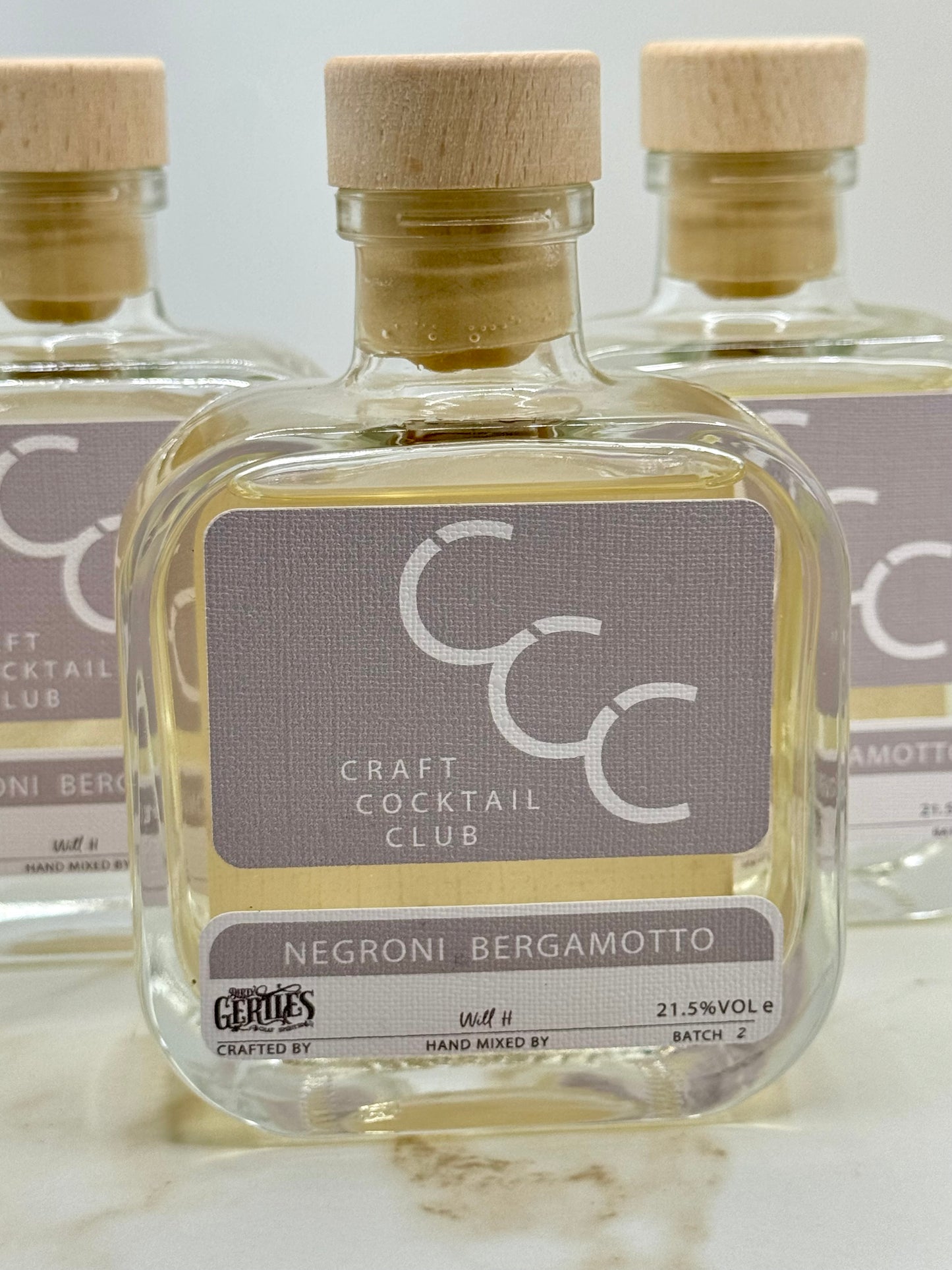 Picture of three bottles of negroni bianco in a Photo Booth setting