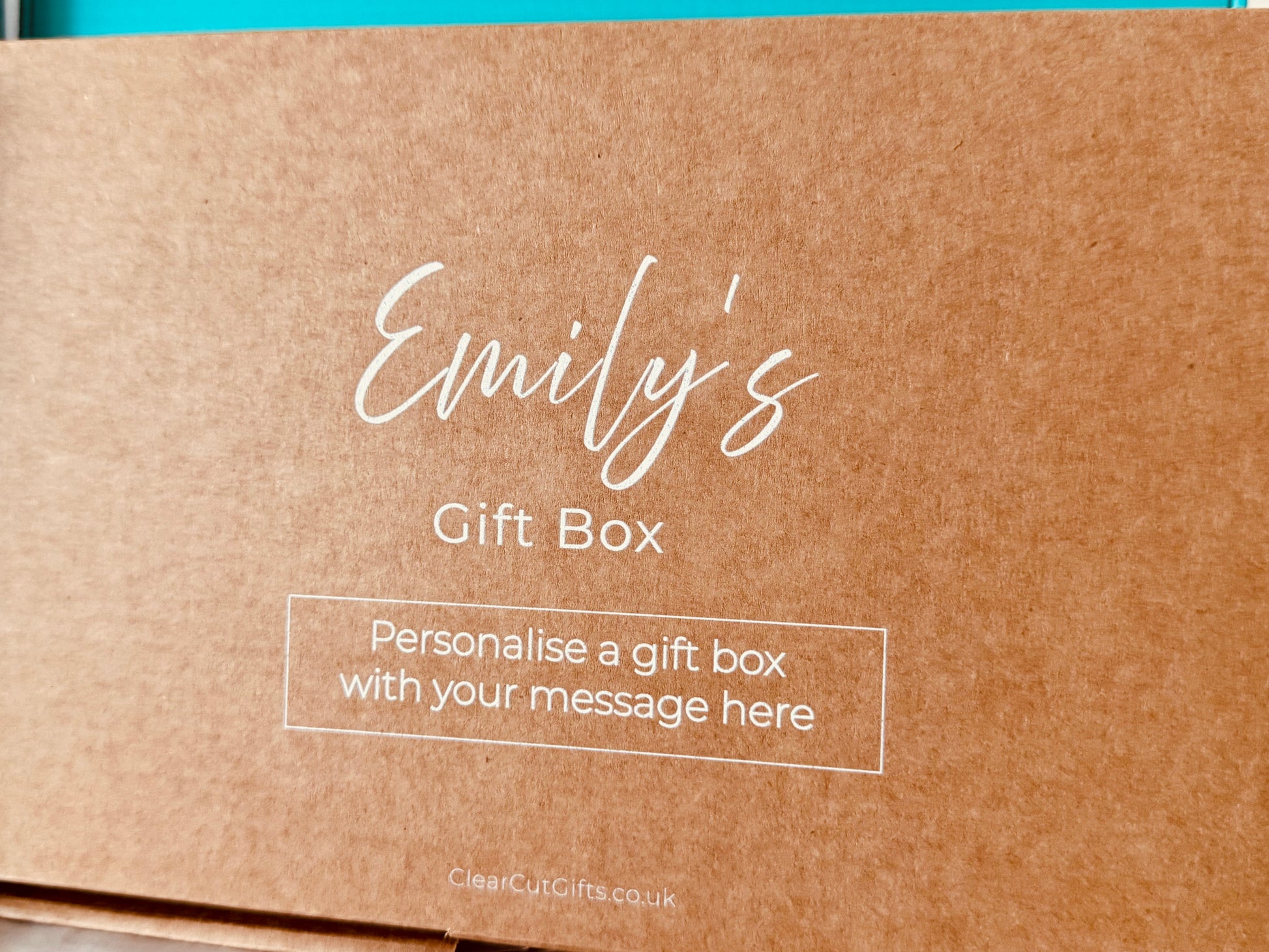 Brown gift box with 'Emily's Gift Box' text and a personal message printed on the box in white