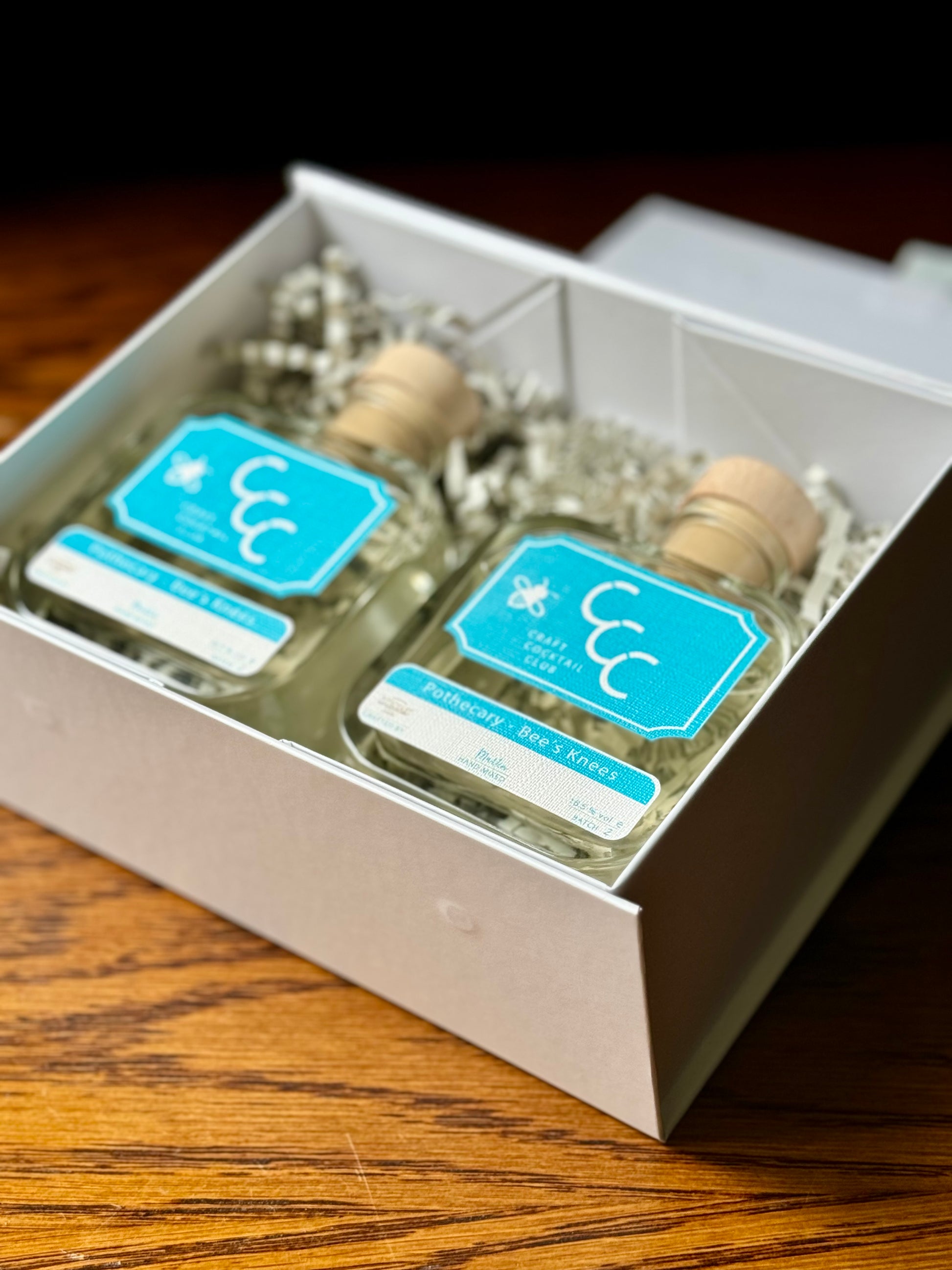 Pothecary Gin gift box, picture of two bottles in a gift box on a dark wooden table 