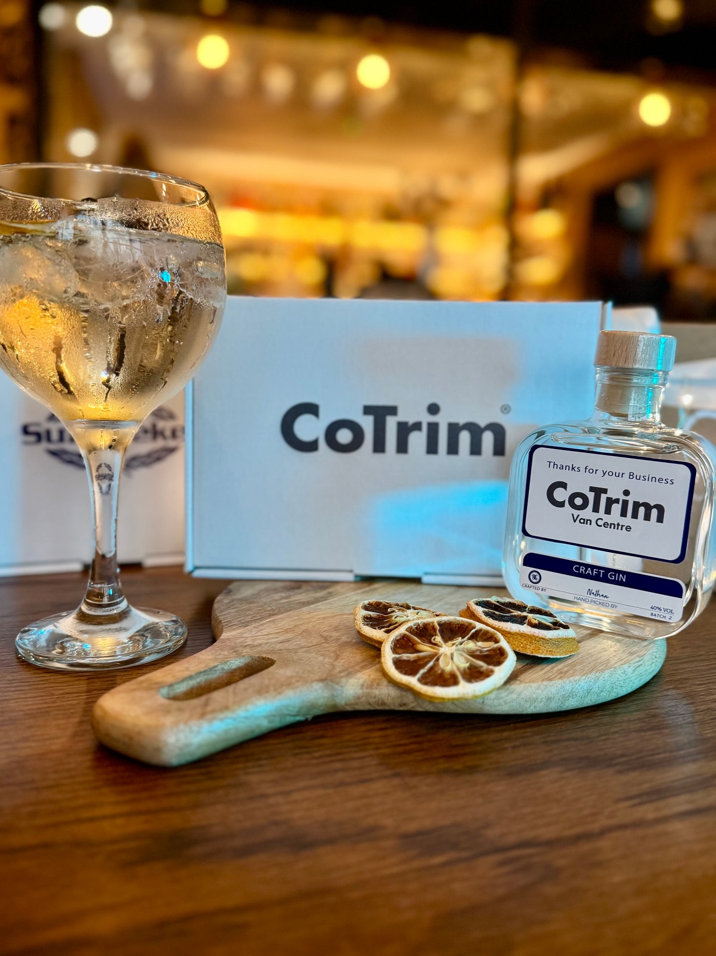 CoTrim bottle and glass on a wooden surface with blurred background