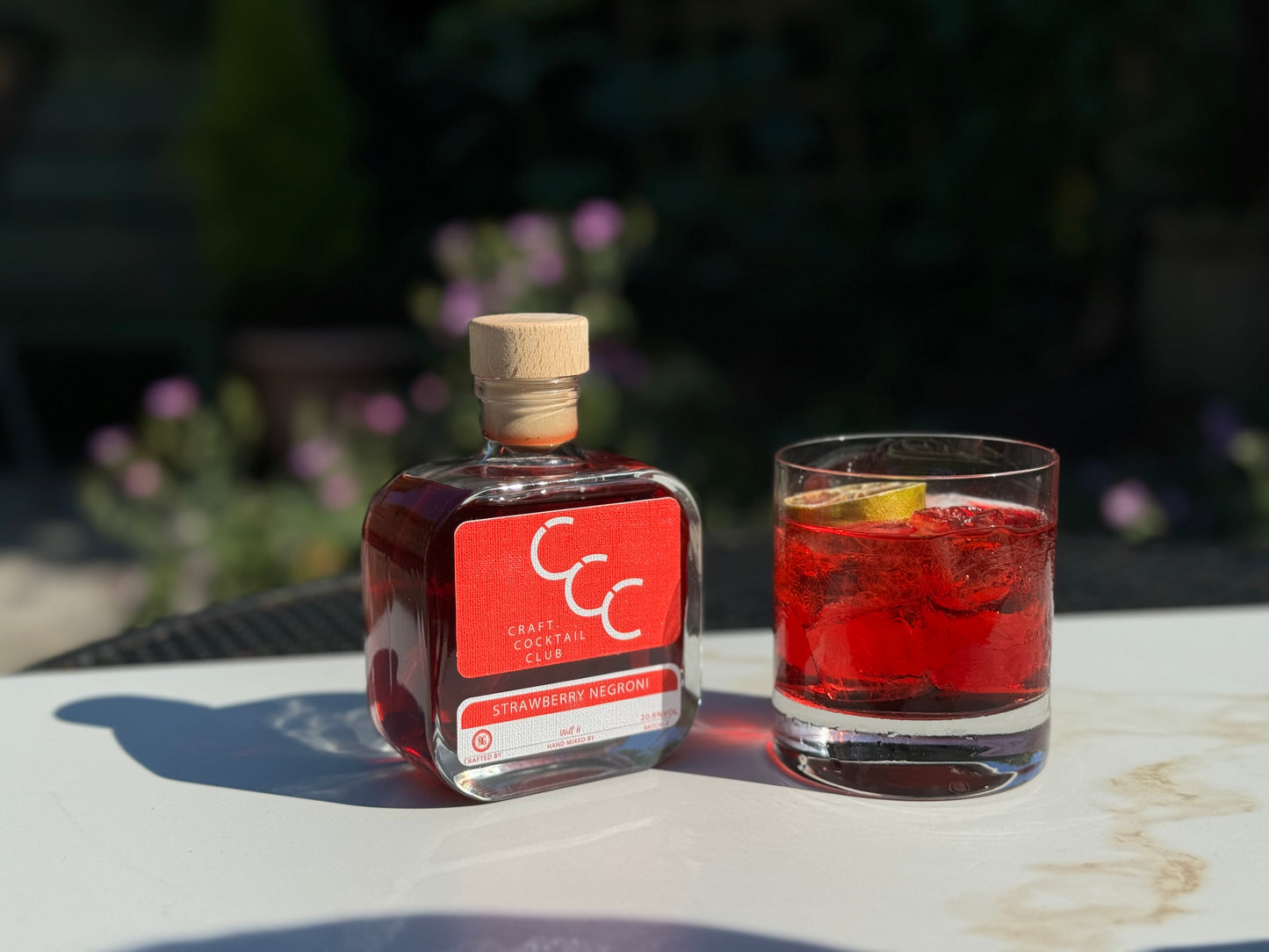 picture of a negroni outside next to a craft cocktail 