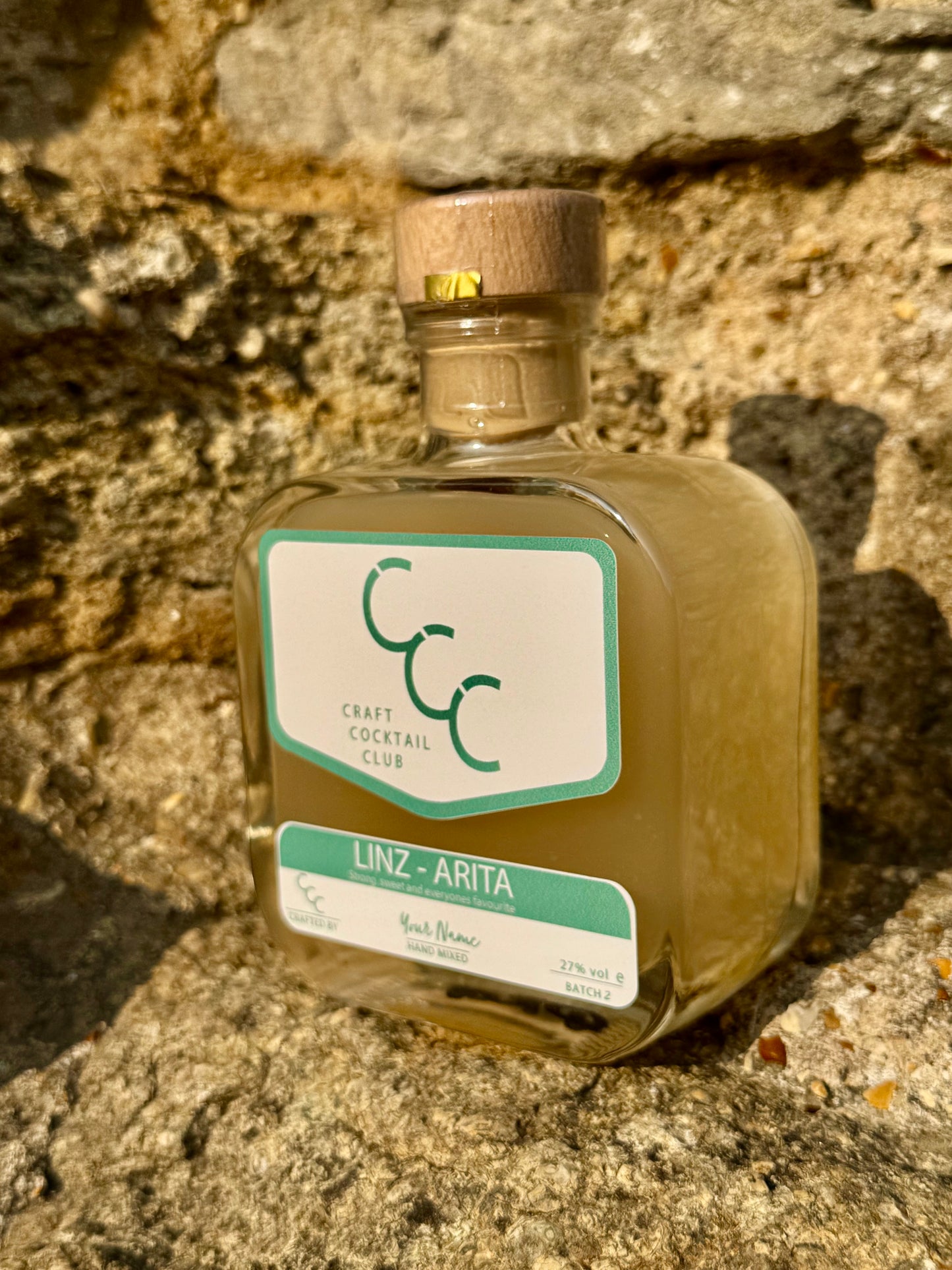 Bottle of Craft Cocktail Club on a stone surface