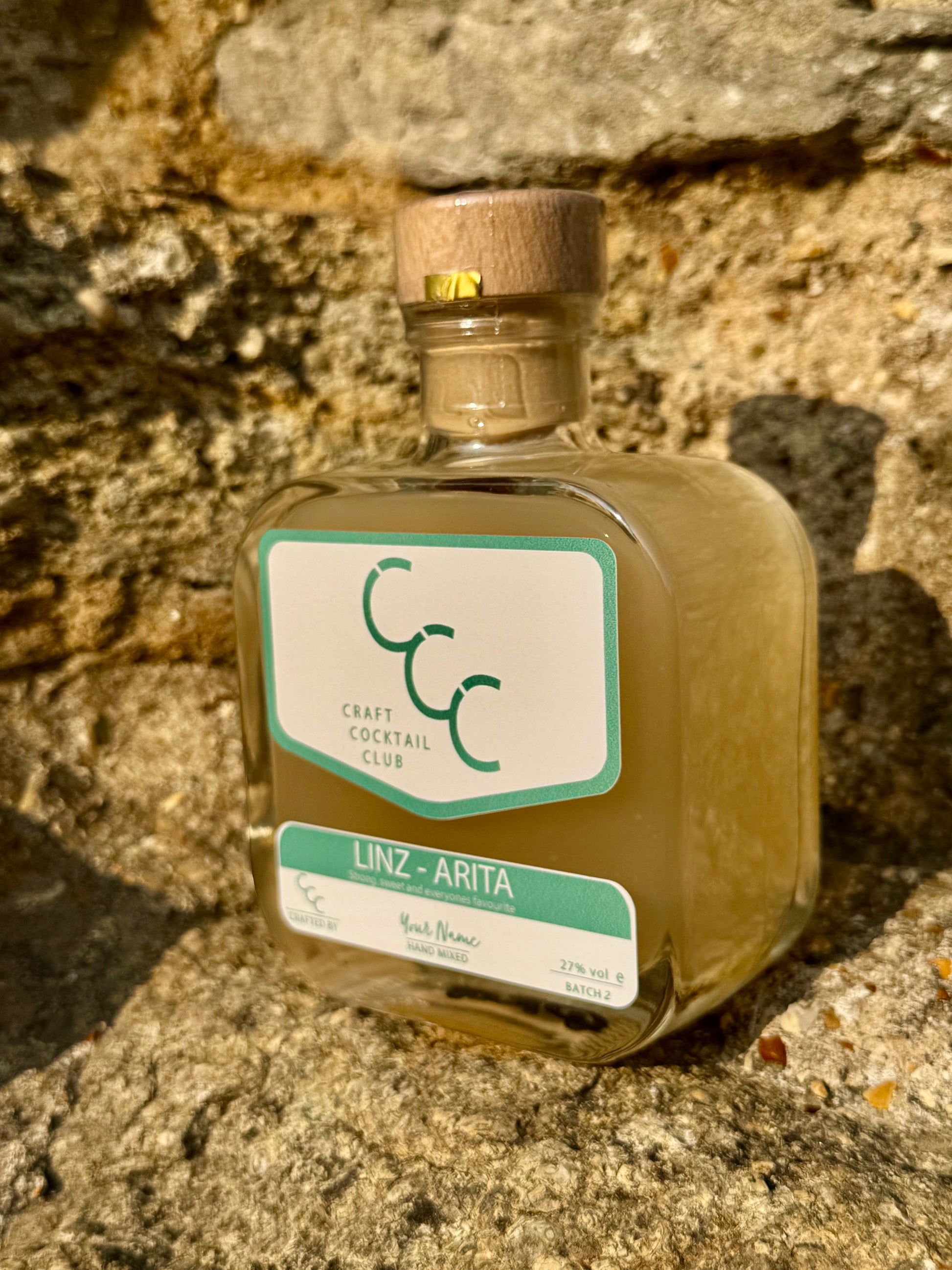 Bottle of Craft Cocktail Club on a stone surface